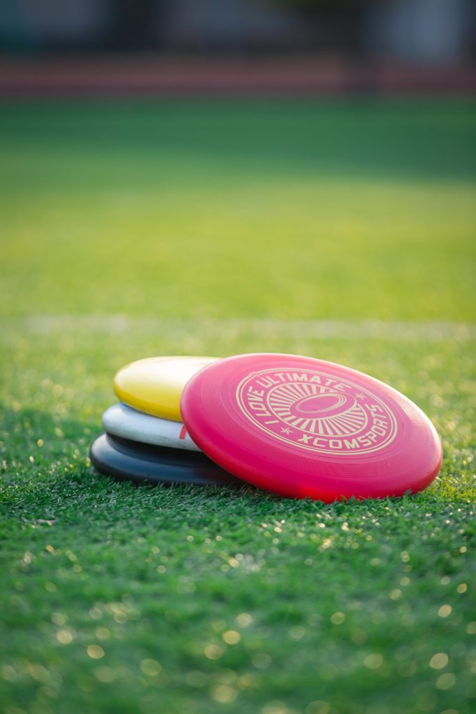 Stack of frisbees on the grass