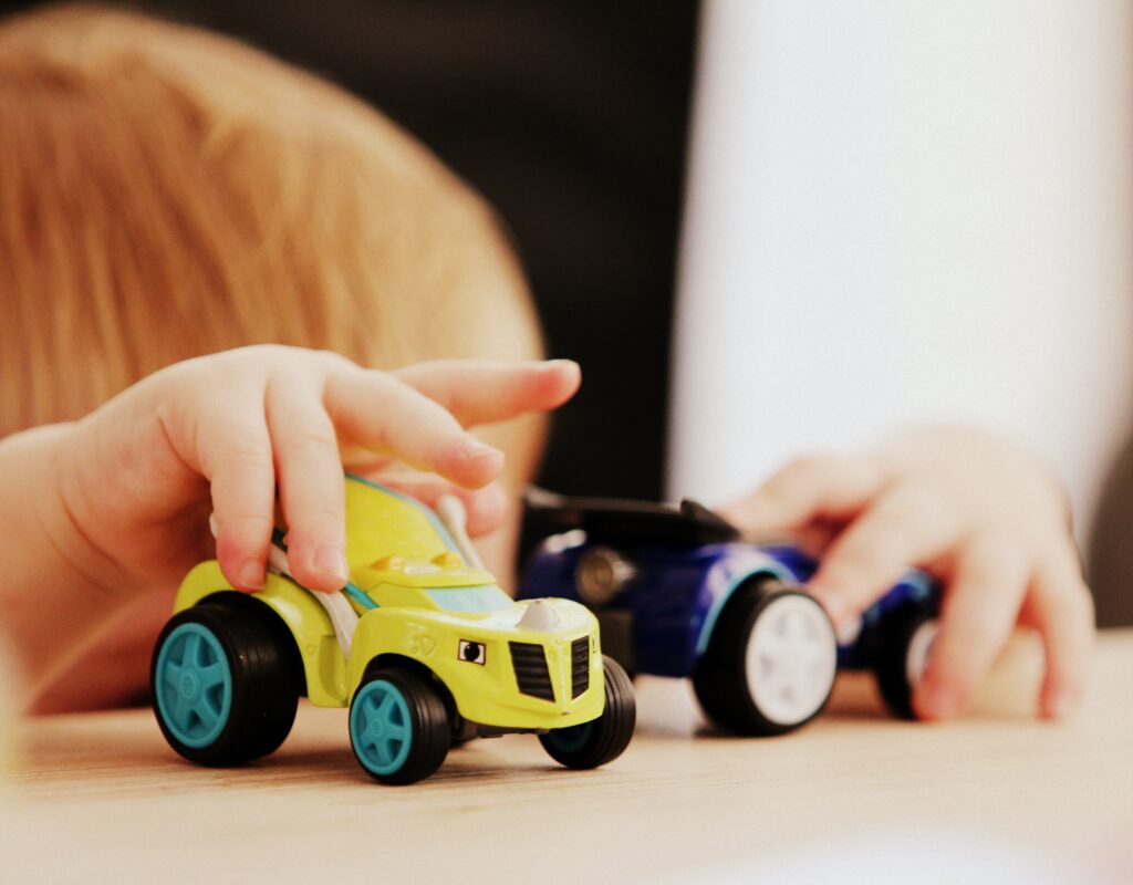 Child plays with toy cars