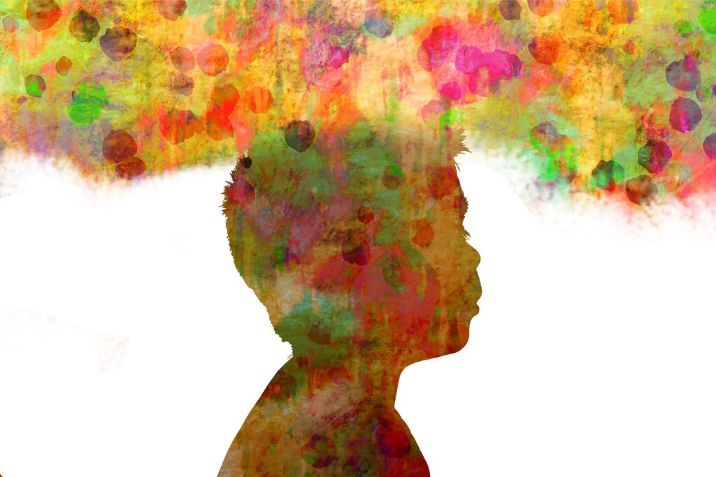 Colorful silhouette of a child from shoulders up with multicolored cloud hovering over head