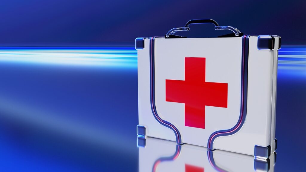 White first aid kit with red cross sits in front of a blue background